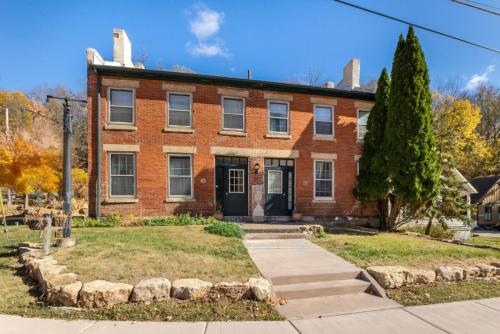 an old brick house with a tree in front of it at Briarstone Inn Unit 4 in Galena