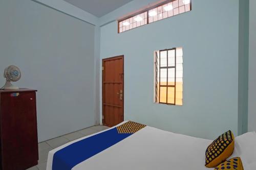 Postel nebo postele na pokoji v ubytování Hotel O Mandiri Inn