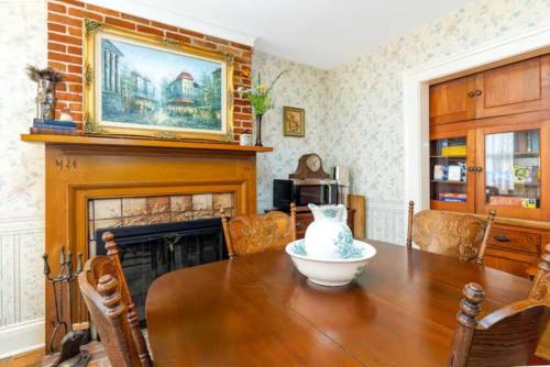 a dining room with a table and a fireplace at Briarstone Inn Unit 4 in Galena