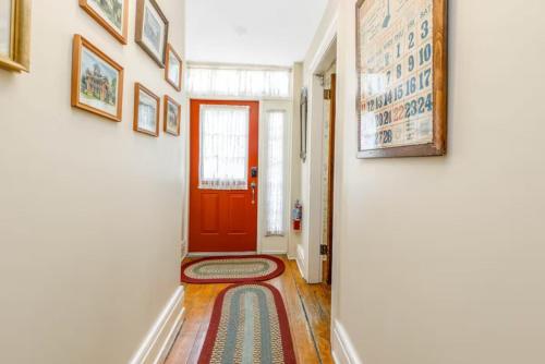 a hallway with a red door and a rug on the floor at Briarstone Inn Unit 4 in Galena