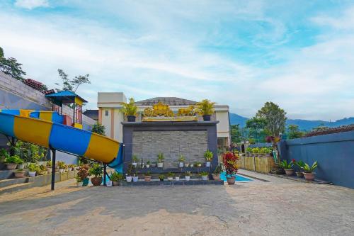 a building with a fire hydrant in front of a building at Collection O 92634 Villa Ds in Sumedang