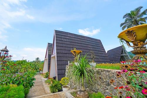 a building with a bunch of flowers in front of it at Collection O 92634 Villa Ds in Sumedang