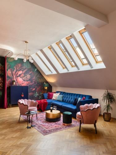 a living room with a blue couch and skylights at Maiselova House in Prague