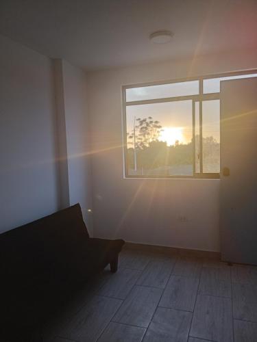 an empty room with a window and a couch at Casa sunampe in Sunampe