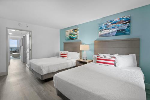 a hotel room with two beds and a room with at Compass Cove in Myrtle Beach
