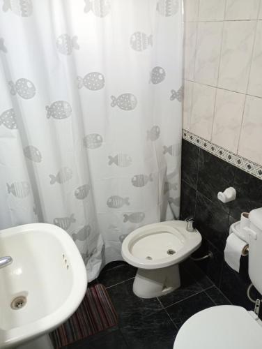 a bathroom with a toilet and a sink at La Serena in Azul