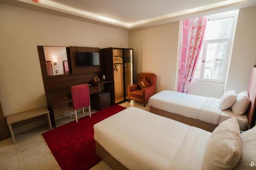 Postel nebo postele na pokoji v ubytování Golden Hoster Hotel Alexandria