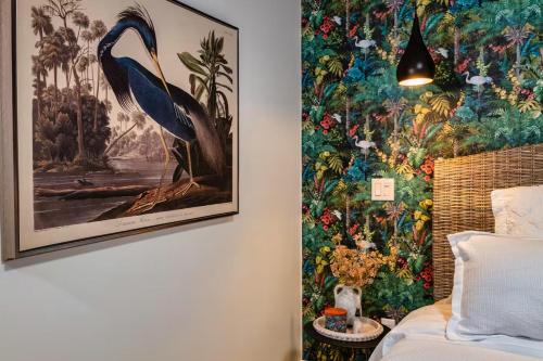 a bedroom with a large painting of a bird on the wall at The Studio Southampton in Southampton