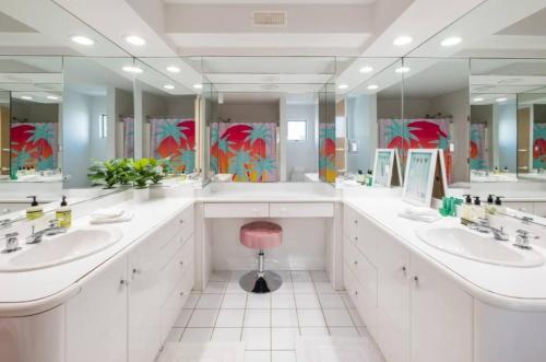 a bathroom with two sinks and two mirrors at Miami Vice Ocean City- 5BR | Private Pool | Views in Ocean City