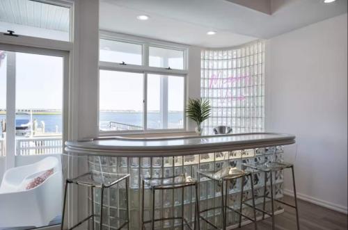 a kitchen with a bar with a view of the ocean at Miami Vice Ocean City- 5BR | Private Pool | Views in Ocean City