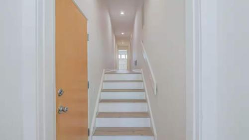 a staircase leading up to a room with white ceilings at Miami Vice Ocean City- 5BR | Private Pool | Views in Ocean City