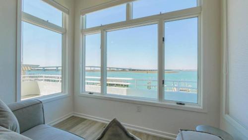 a living room with large windows with a view of the ocean at Miami Vice Ocean City- 5BR | Private Pool | Views in Ocean City