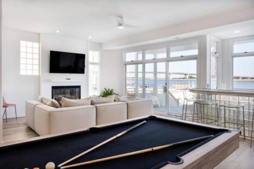 a pool table in a living room with a couch and a fireplace at Miami Vice Ocean City- 5BR | Private Pool | Views in Ocean City