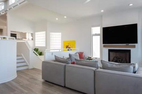 a living room with a white couch and a fireplace at Miami Vice Ocean City- 5BR | Private Pool | Views in Ocean City