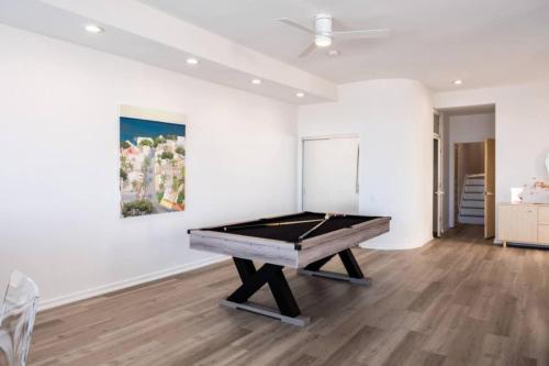 a pool table in a room with a painting at Miami Vice Ocean City- 5BR | Private Pool | Views in Ocean City