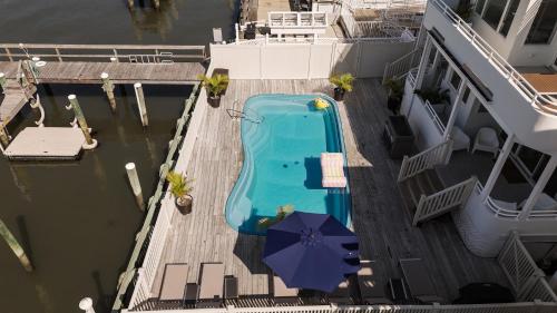 a swimming pool on a cruise ship with an umbrella at Miami Vice Ocean City- 5BR | Private Pool | Views in Ocean City