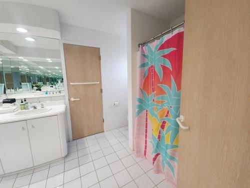 a bathroom with a shower curtain with a flower on it at Miami Vice Ocean City- 5BR | Private Pool | Views in Ocean City