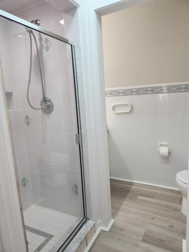 a bathroom with a shower and a toilet at Miami Vice Ocean City- 5BR | Private Pool | Views in Ocean City
