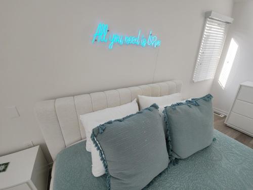 a bedroom with a bed with aall you need is love sign at Miami Vice Ocean City- 5BR | Private Pool | Views in Ocean City