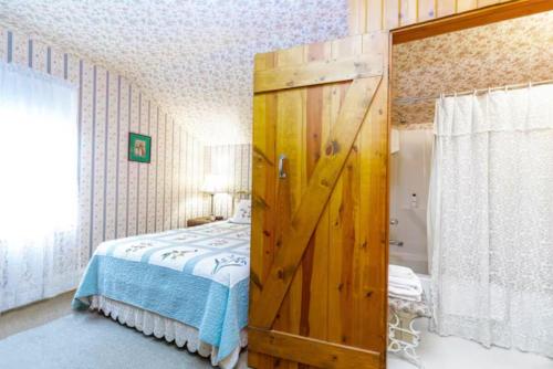 a wooden door in a bedroom with a bed at Briarstone Inn Unit 5 in Galena