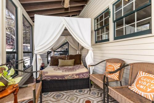 a screened in porch with a bed and two chairs at Briarstone Inn Unit 5 in Galena