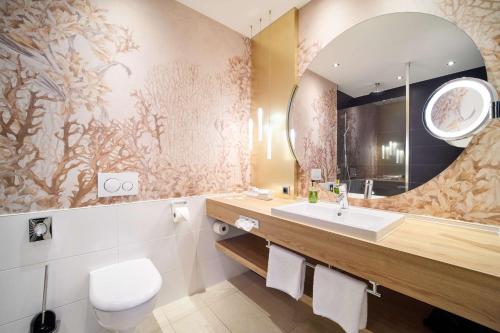 a bathroom with a sink and a mirror at Best Western Premier Park Hotel & Spa in Bad Lippspringe