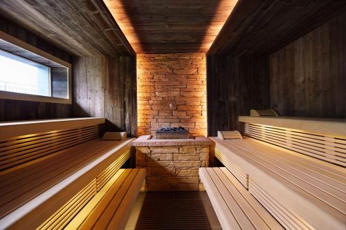a sauna with wooden benches and a window at Best Western Premier Park Hotel & Spa in Bad Lippspringe