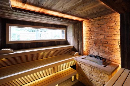 a sauna with a window and a brick wall at Best Western Premier Park Hotel & Spa in Bad Lippspringe