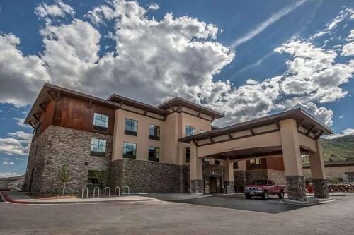 a building with a car parked in front of it at Homewood Suites by Hilton, Durango in Durango