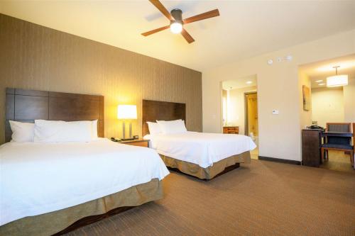 a hotel room with two beds and a ceiling fan at Homewood Suites by Hilton, Durango in Durango