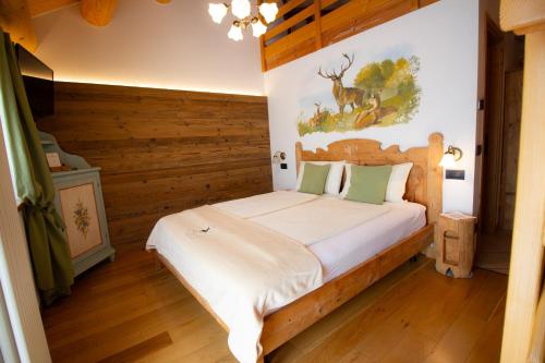 a bedroom with a bed with a wooden wall at Ongar Relax b&b in Bosco Chiesanuova