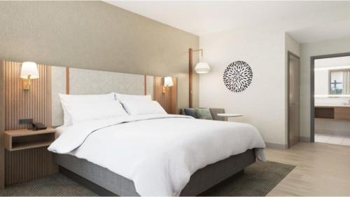a large white bed in a hotel room at Holiday Inn Morgantown - Reading Area by IHG in Morgantown