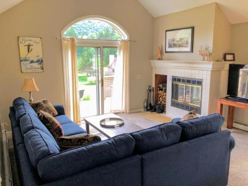 a living room with a blue couch and a fireplace at FV16 Fairway Village Condo in Carroll
