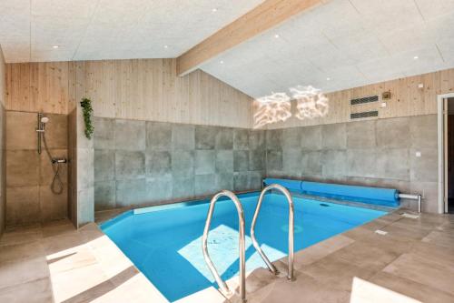 a bathroom with a swimming pool and a shower at Feriehus 1115 in Hvide Sande