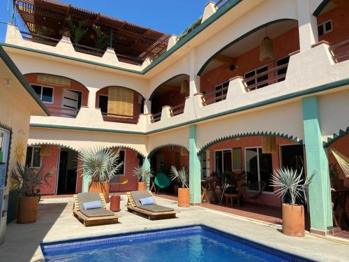 a house with a swimming pool in front of it at Pineapple Mansion in Paso Hondo