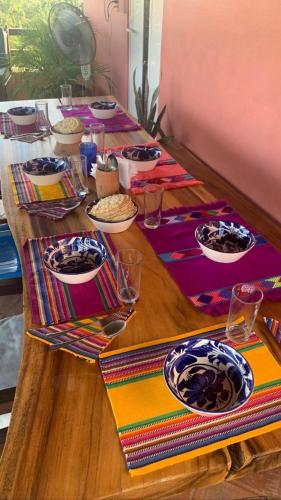 a wooden table with plates of food on it at Pineapple Mansion in Paso Hondo