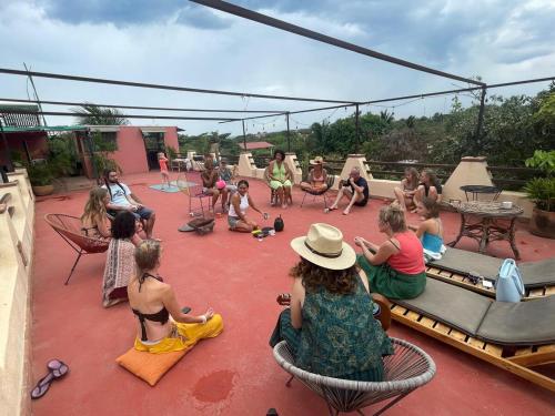 a group of people sitting in chairs on a patio at Pineapple Mansion in Paso Hondo