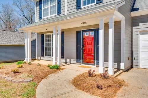 a house with a red door and a driveway at 10 Mi to Six Flags Austell Home with Expansive Yard in Austell