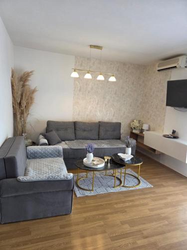 a living room with a couch and a table at VILA MARIJA in Mimice