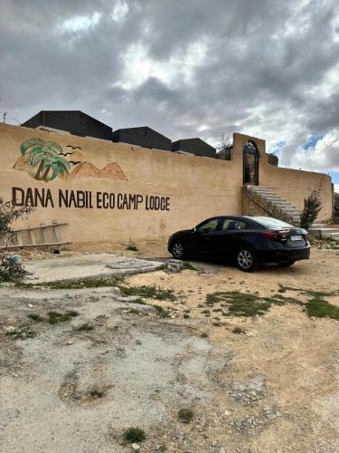 a black car parked in front of a building at Dana Valley Tourism Hotel in Dana