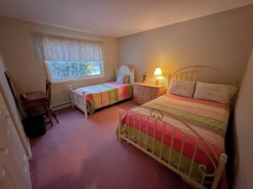 a small bedroom with two beds and a window at FV22 Great Location close to Bretton Woods Ski Area in Carroll
