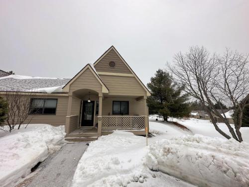 a house with snow on the ground in front of it at FV22 Great Location close to Bretton Woods Ski Area in Carroll