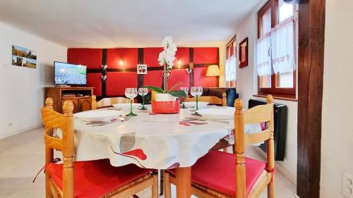 a dining room with a table with wine glasses at Gite A la Fontaine Bergheim in Bergheim