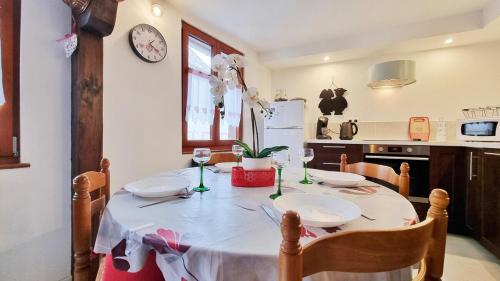 a dining room table with a white table cloth on it at Gite A la Fontaine Bergheim in Bergheim