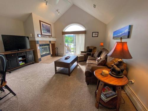 a living room with a couch and a table at FV23 Awesome on golf course in Bretton Woods with Mountain Views in Carroll