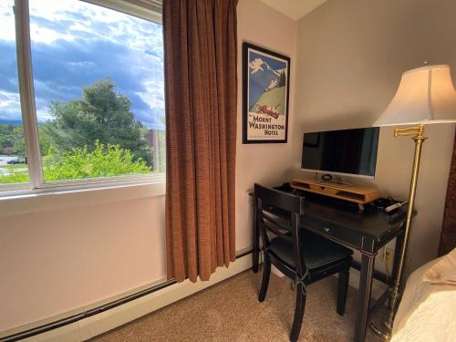a bedroom with a desk with a television and a window at FV23 Awesome on golf course in Bretton Woods with Mountain Views in Carroll