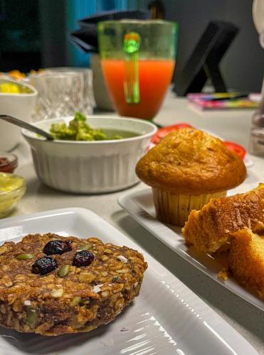 a table with two plates of muffins and cupcakes at The Studio Southampton in Southampton
