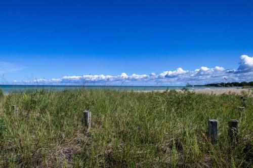 a beach with a fence in the grass at The Studio Southampton in Southampton