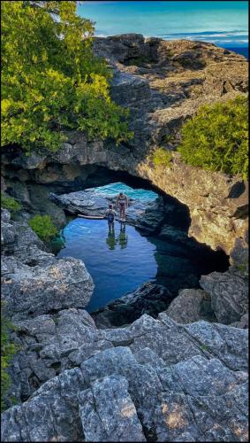 two people standing in a pool of water in a cave at The Studio Southampton in Southampton