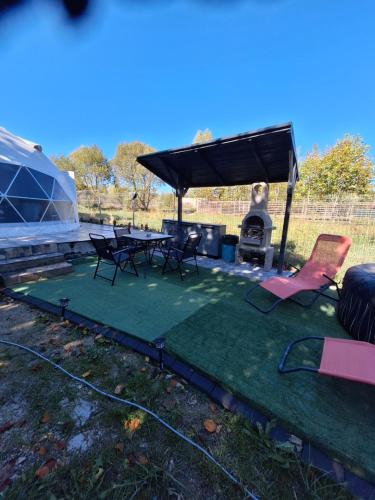a patio with a table and chairs and a grill at Igloo Rasnov in Râşnov